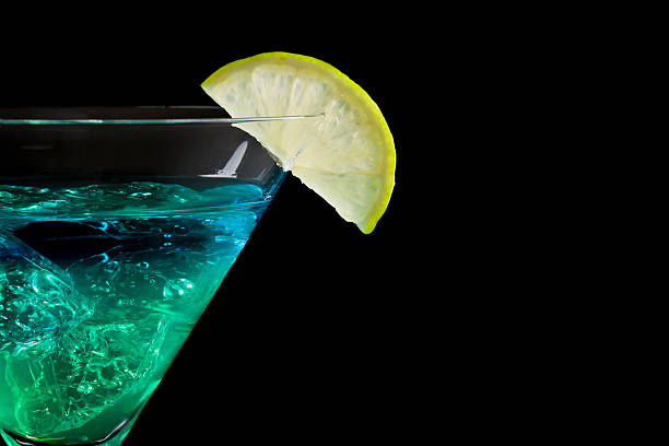 istock blue and green drink in martini glass isolated on black 153701388