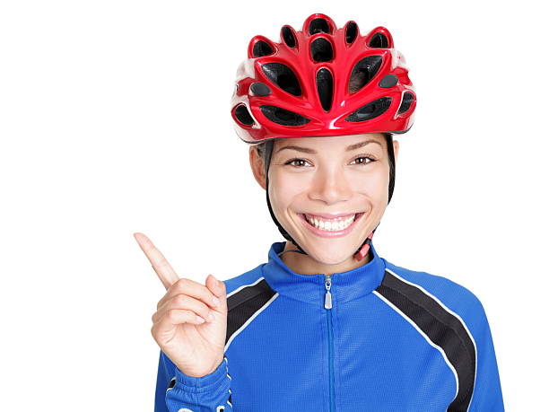 casco da bicicletta donna che indica su bianco - aiming cycling isolated showing foto e immagini stock