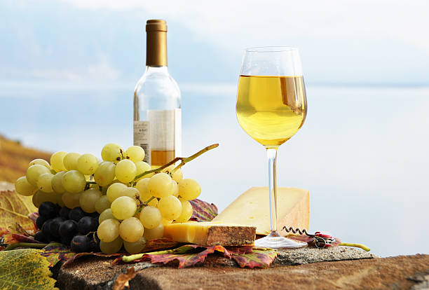 Wineglass, cheese and grapes Wineglass, cheese and grapes on the terrace of vineyard in Lavaux region, Switzerland montreux photos stock pictures, royalty-free photos & images