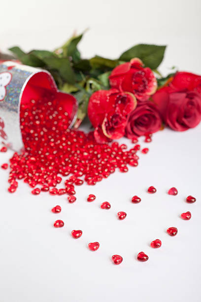 istock Heart shaped red gems with gift box and roses behind 153702146