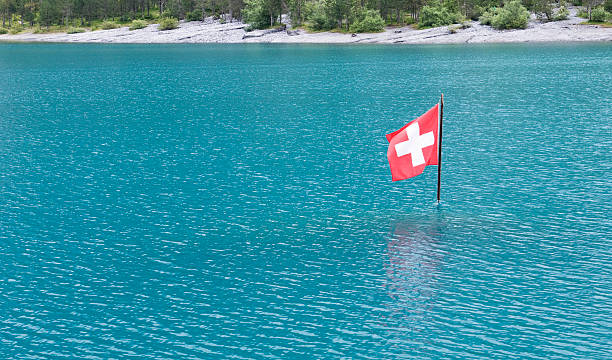 Oeschinensee with Swiss flag in the lake.