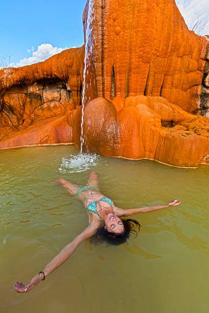istock Young woman  relaxing in a hotspring pool. 153702762