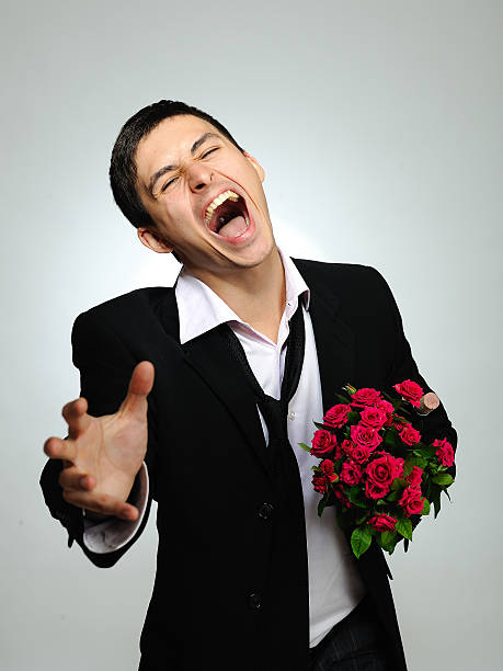 Expressions. screaming husband holding rose flower stock photo