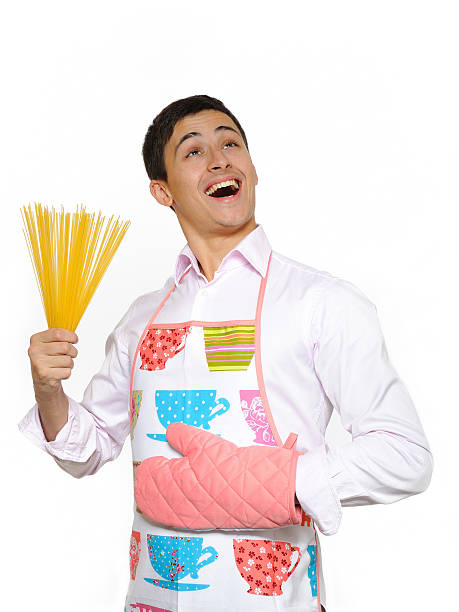 young happy cook man with spagetti pasta. isolated on white stock photo