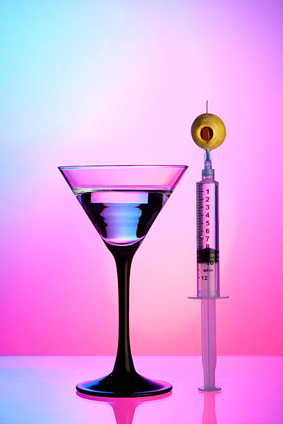 Syringe, olive, and cocktail stock photo