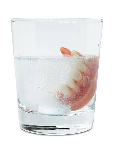 istock False teeth in cleaning water glass 153703494