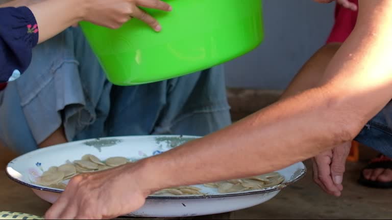 Workers pack traditional fish crackers in clear plastic packages