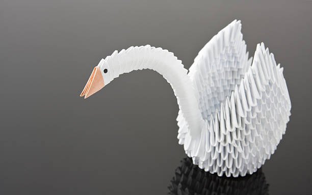 istock White origami swan on grey surface 153704248