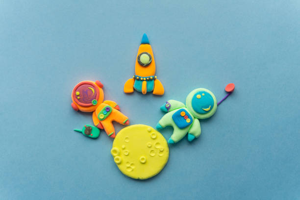 istock Astronauts On The Moon. Astronaut Is Made Out Of Play Clay. Spaceship, moon and two cute cosmonauts 1537054380