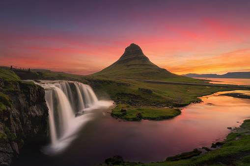 Kirkjufell mountain and river in Iceland in summer season. Famous landscape nature background at sunset