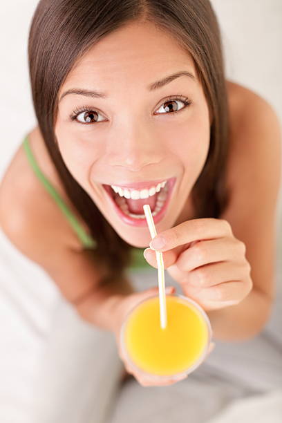 istock Woman drinking orange juice 153706913