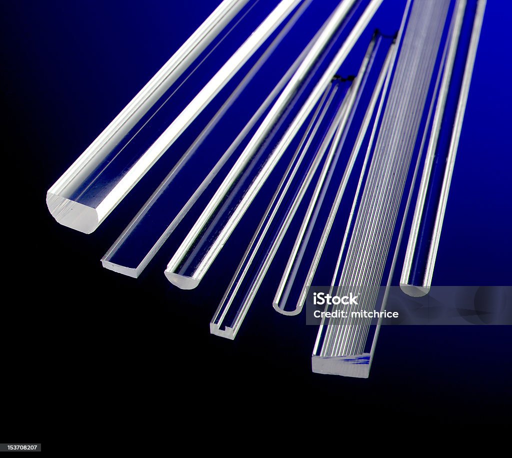 Glass rods with colorful glow Glass rods of various shapes, sizes, and textures floating over a glowing colorful background. Black Color Stock Photo