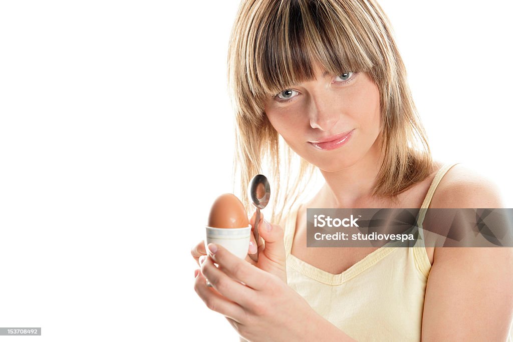 Woman eating boiled egg Young woman holding hard-boiled egg Eating Stock Photo