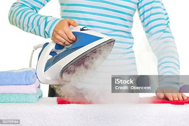 Young Lady Ironing Her Clothes Stock Photo - Download Image Now - Adult, Appliance, Blue