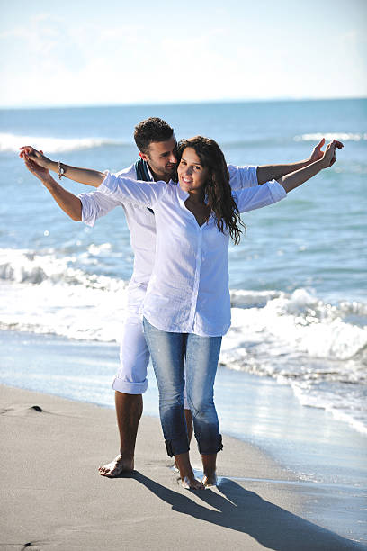 istock happy young couple have fun at beautiful beach 153710377