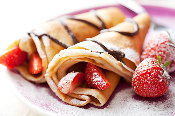 crepes close up of two french style crepes, shallow dof. Some ingredients in the background crêpe pancake photos stock pictures, royalty-free photos & images