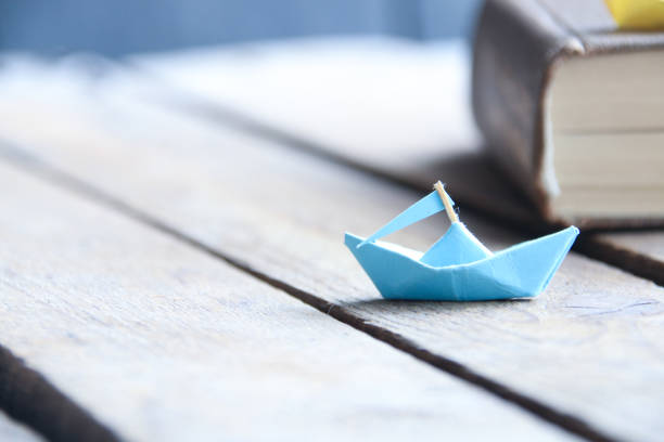 istock Back to school. Paper boat and book. 1537108700