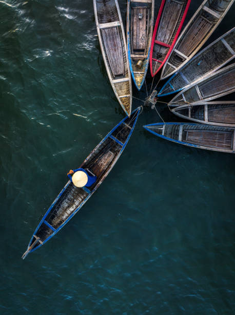 Hoi An Vietnam - November  16, 2022:Directly above the colourful long tail boats moored to the causeway on the Thu Bon River, the ancient city of Hoi An, Quang Nam Province, Vietnam.