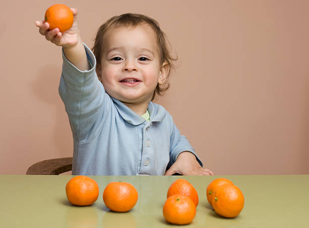 istock baby boy with tangerines 3 153711039