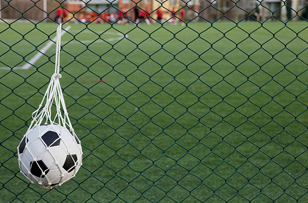 istock soccer ball in the net 153711042