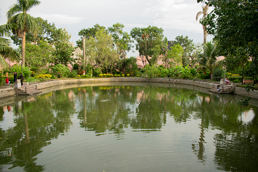 108 shiva temple, kalna, burdwan, west bengal, india - july 06, 2023 : tranquil pond inside the temple premises surrounded by abundant greenery