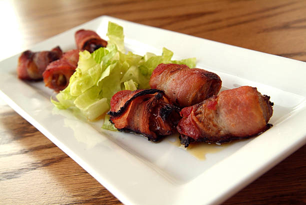 Bacon wrapped dates stock photo