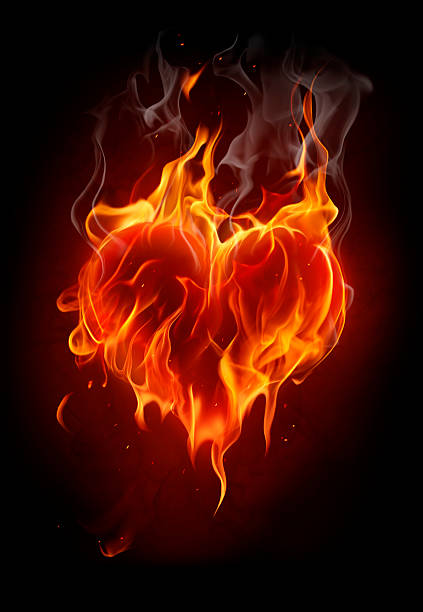 Flaming heart on black background stock photo
