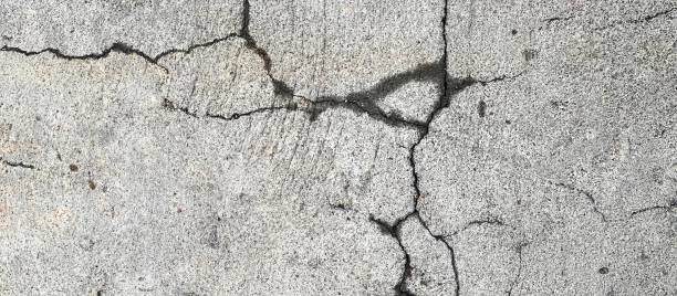 istock nailing on a concrete surface with a crack in the middle. 1537119722
