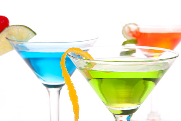 Tropical citrus martini Cocktails with vodka, light rum, gin, tequila, blue curacao, lime juice, lemonade, lemon slice, maraschino cherry isolated on a white background