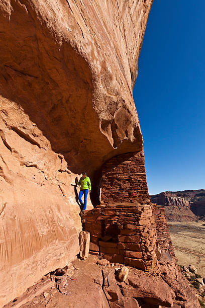 istock Hiker explores an ancient Anasazi cliff-dwelling. 153714831