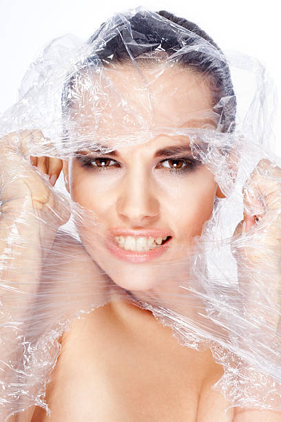 istock Beautiful girl breaks a plastic bag. 153715013