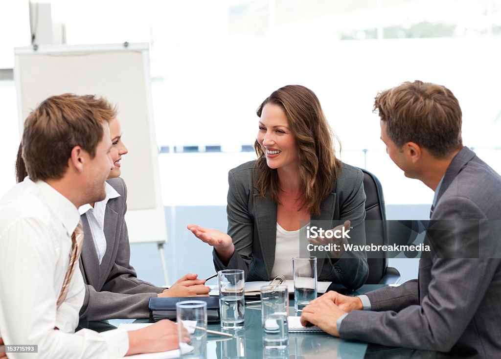 Attractive businesswoman laughing with her team Attractive businesswoman laughing with her team during a meeting 30-34 Years Stock Photo