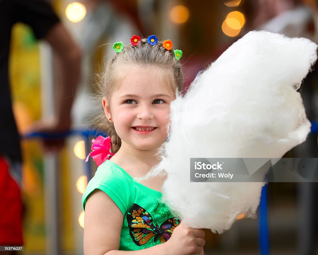 Four years old girl with white cotton candy girl eating white cotton candy Beautiful People Stock Photo