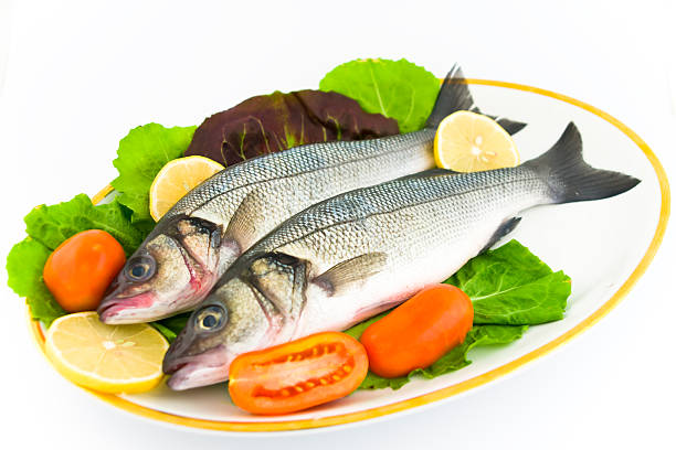 Fresh sea bass  with vegetables, ready to cook