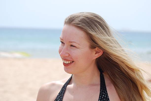 istock blond smiling women with hair flying 153716674
