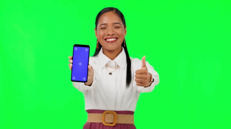 Phone, green screen and thumbs up with business woman and tracking markers for show, social media and yes. Success, website and contact with portrait of employee on background for technology mockup