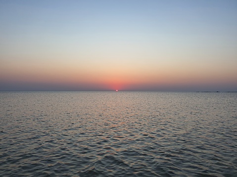 early in the morning, on the shore of the red sea