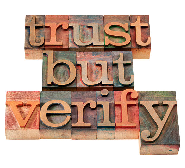 trust but verify phrase trust but verify  quote from  Ronald Reagan concerning relations with Soviet Union - vintage wooden letterpress printing blocks, stained by color inks, isolated on white printing block photos stock pictures, royalty-free photos & images