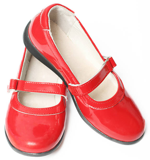 Red children's varnished shoes isolated on white background