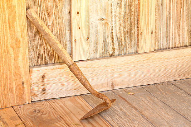 Old Gardening Hoe In Rustic Setting On Farmhouse Porch