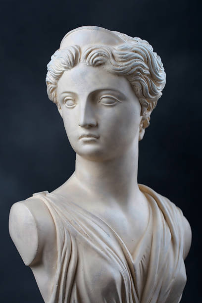 Artemis - Stone bust A copy of a stone bust of the Greek Goddess Artemis, daughter of Zeus, twin sister of Apollo.  This photograph provides a 2/3 view of the face and has dramatic low key lighting. statue stock pictures, royalty-free photos & images