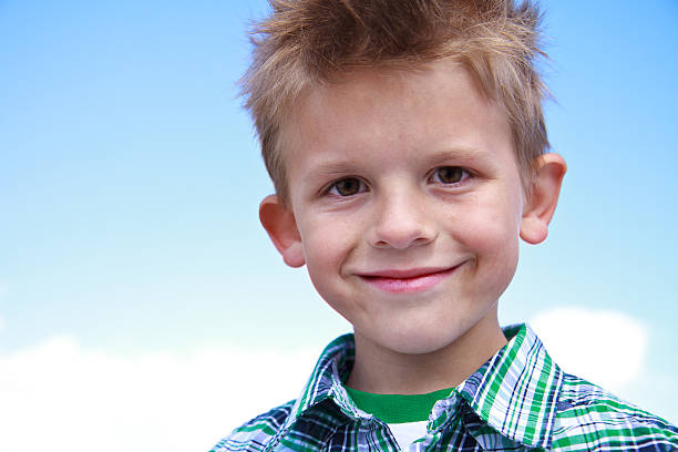 Cute young boy smiling at the viewer stock photo