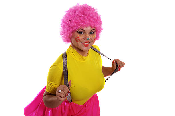 Hilarious clown in a pink wig. young girl in a bright wig and clown makeup. drag shw stock pictures, royalty-free photos & images