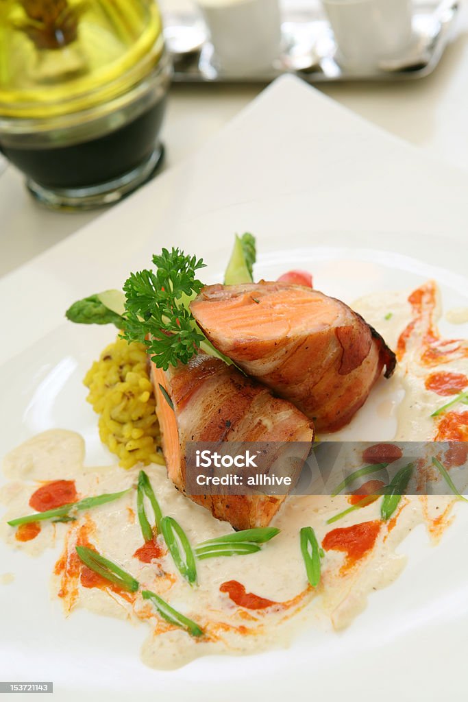 Pan-Fried Salmon Fillet wrapped with Italian Bacon and Horseradish Sauce Appetizer Stock Photo