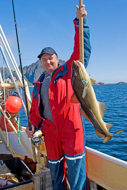 istock Fisherman with big fish and the spinning 153721226