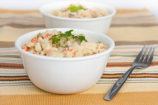 Two bowls of potato salad on yellow napkin stock photo