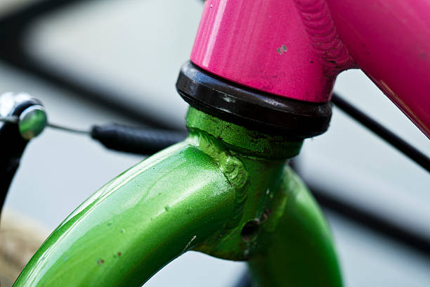 Part of a pink (fuchsia) and green bicycle