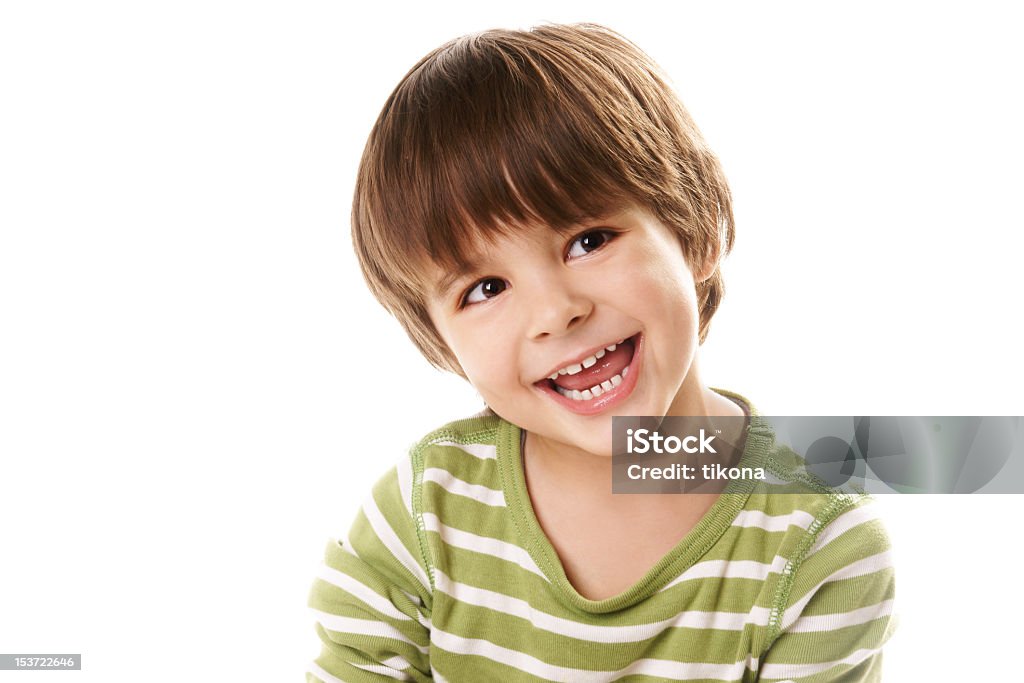 Young boy laughing in green top against white background Portrait of happy joyful beautiful little boy isolated on white background Beautiful People Stock Photo