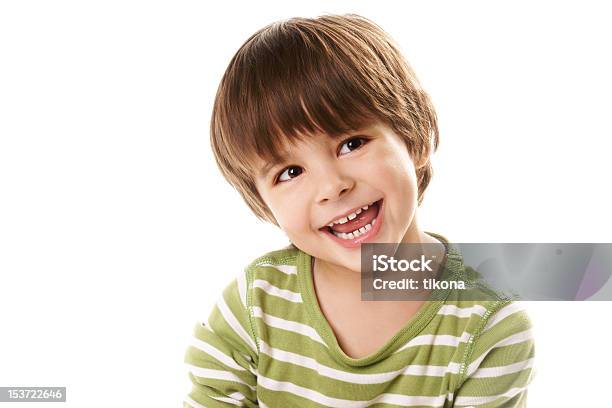 Young Boy Laughing In Green Top Against White Background Stock Photo - Download Image Now