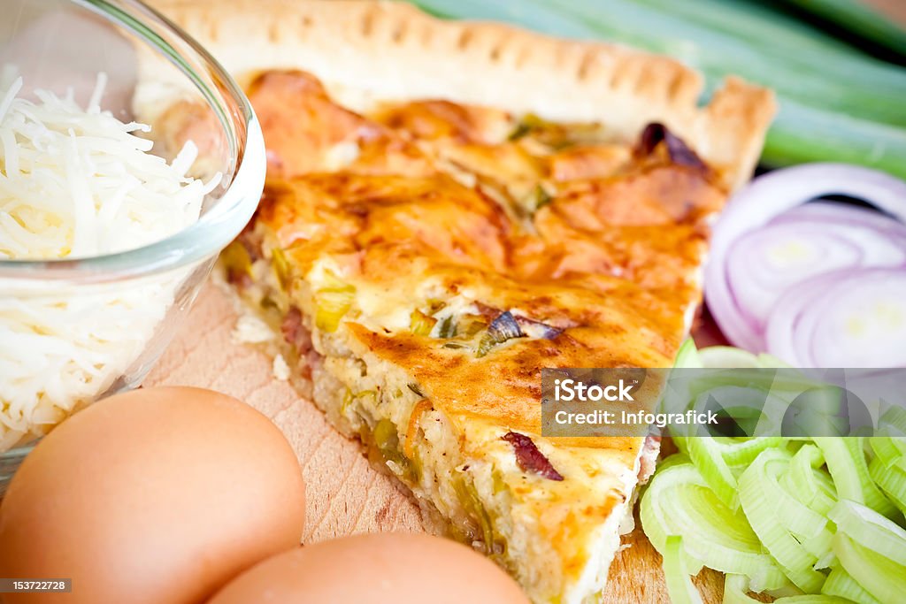 Quiche Lorraine ingredients French Quiche Lorraine with ingredients on wood cutting board. Animal Egg Stock Photo